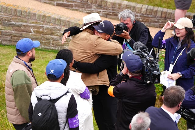 Xander Schauffele hugs his father Stefan after winning the Open