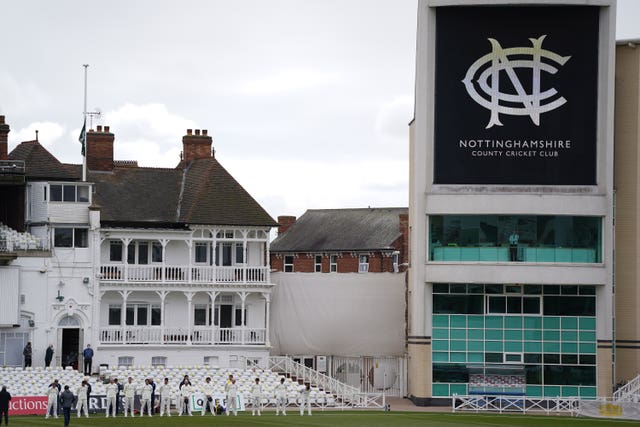 Durham players stand for a minute's silence as the flag is flown at half mast at Trent Bridge