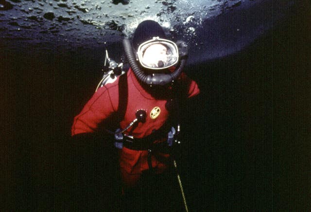 Charles diving under the ice at Resolute Bay, Canada in April 1975