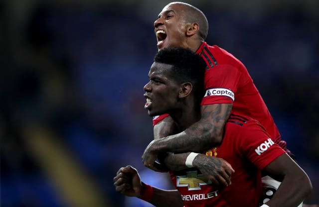 Paul Pogba, bottom, and Ashley Young celebrate