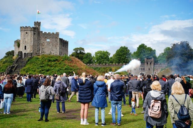 Spectators watch members of the 104 Regiment Royal Artillery during the Gun Salute at Cardiff Castle