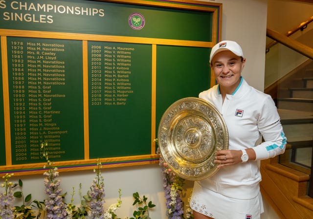 Ashleigh Barty poses next to the honours board