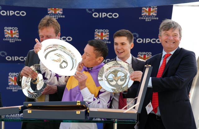 Frankie Dettori (centre) with the trophy after winning the Qipco British Champions Sprint Stakes with Kinross 