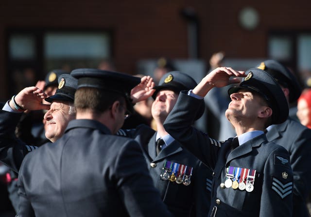 RAF personnel look to the skies as the Tornado flies overhead