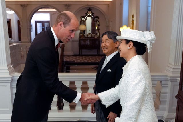The Prince of Wales shakes hands with the Empress of Japan