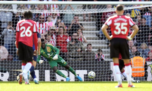 Andre Onana dives to his right to save Cameron Archer''s penalty