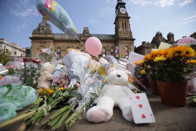 Flowers, teddy bears and balloons left in tribute