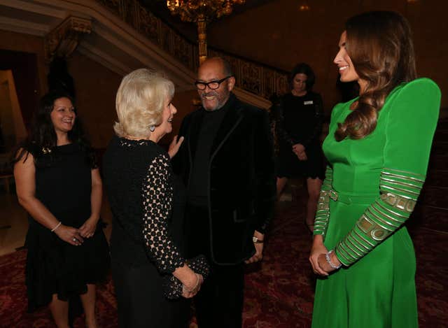 Camilla meets Bruce Oldfield (centre) as she attends the Bruce Oldfield Fashion Show at Lancaster House (PA)