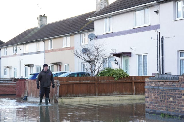 A person walks down a flooded street in Loughborough