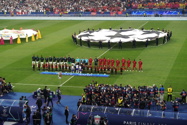 Real Madrid and Liverpool players line up before kick-off