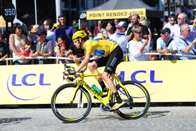 Bradley Wiggins, in the yellow jersey and riding a yellow bike