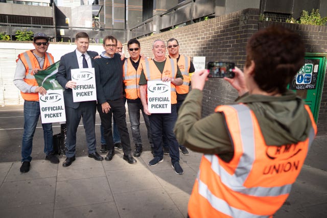 Rail workers form a picket line at Euston Station in London