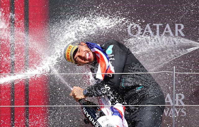 Lewis Hamilton is sprayed with champagne while celebrating his British Grand Prix win