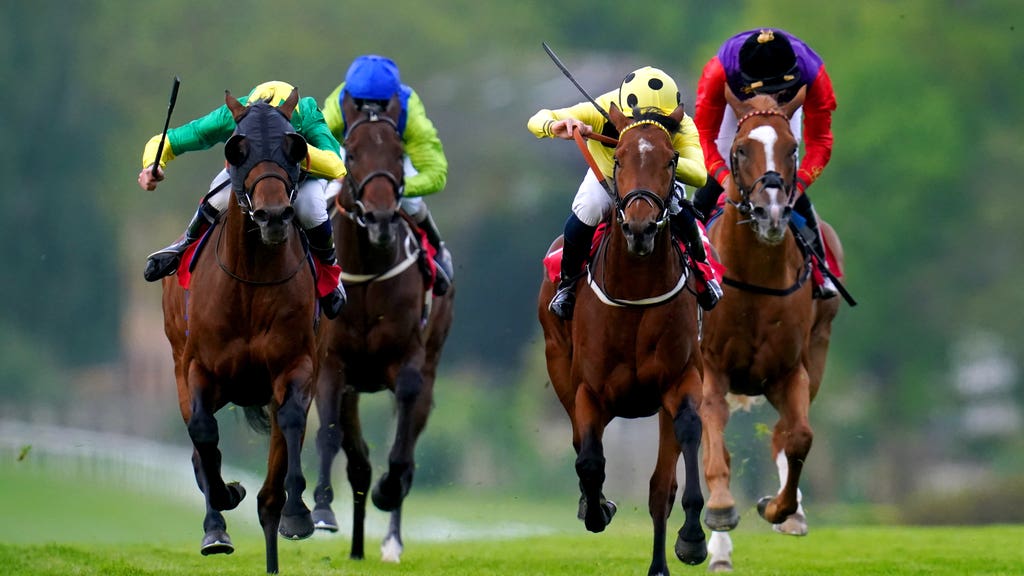Captain Winters ridden by jockey Neil Callan (second right) on their way to winning the Heron Stakes at Sandown Park Racecourse, Surrey.