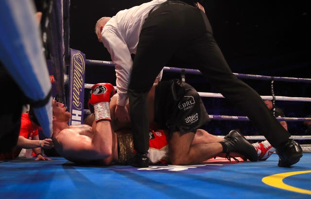 The referee intervenes as David Price (left) is bitten on the torso by Kash Ali during their heavyweight bout