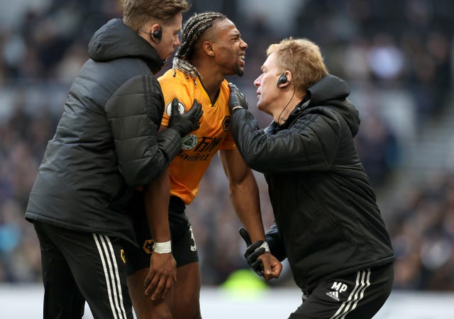 Adama Traore, centre, reacts after picking up another shoulder injury