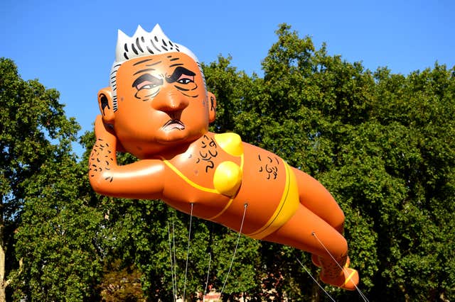 An inflated blimp of London mayor Sadiq Khan depicted in a bikini 