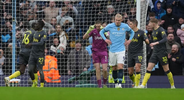 Erling Haaland puts his hands on his hips in frustration after seeing his penalty saved against Everton