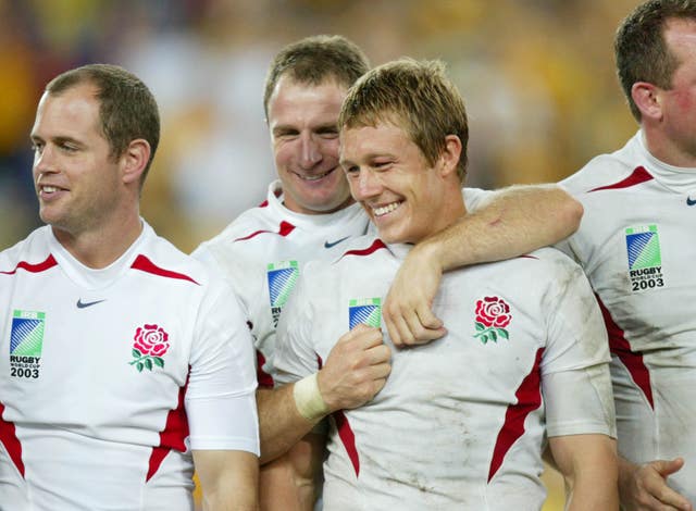 Jonny Wilkinson (centre right) is congratulated by team-mate Mike Catt after his drop goal clinched the 2003 Rugby World Cup