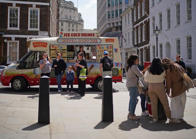 People buying ice cream from an ice cream van near St James’s Park, London