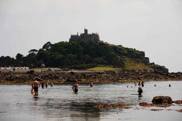 People cooling down in the sea at St Michael’s Mount in Cornwall
