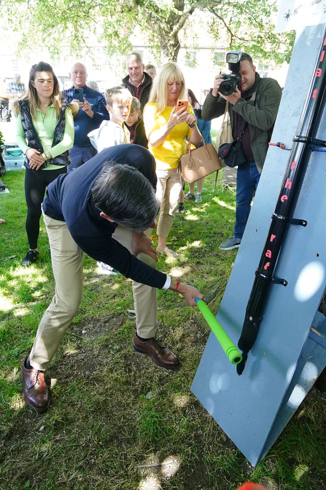 Prime Minister Rishi Sunak playing Splat the Rat at a village fete in Great Ayton, Yorkshire, while on the General Election campaign trail