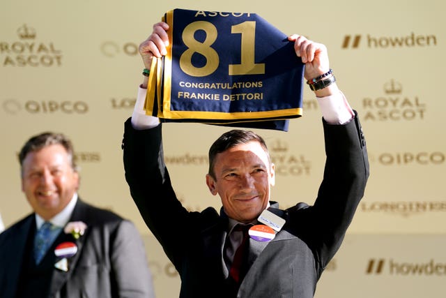 Dettori holds a commemorative saddlecloth to show his number of Royal Ascot winners