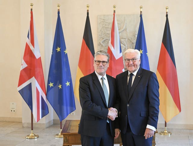 Sir Keir with German president Frank-Walter Steinmeier at the Bellevue Palace, shaking hands in front of a rank of flags