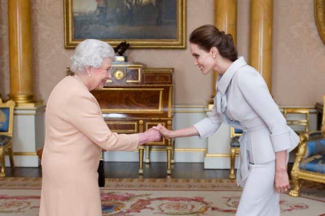 Hollywood star Angelina Jolie pictured meeting the Queen in 2014 as she was made an honorary dame by the monarch for her campaigning work fighting sexual violence. (Anthony Devlin/PA)