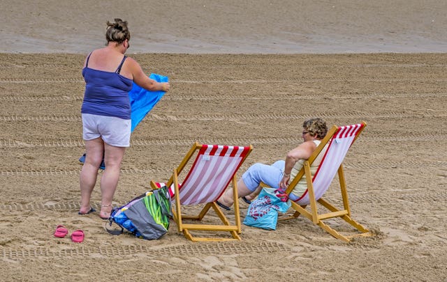 Two women use some of the new deckchairs (Peter Byrne/PA)