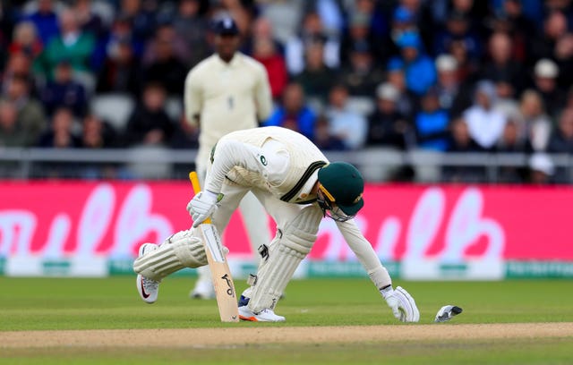 Litter on the pitch disrupts play during day one of the fourth Ashes Test at Emirates Old Trafford
