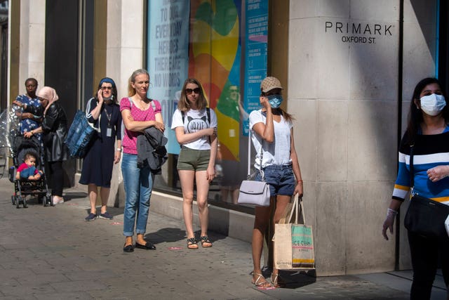 Keen shoppers wore masks and queued two metres apart as shops in England reopened (Victoria Jones/PA)