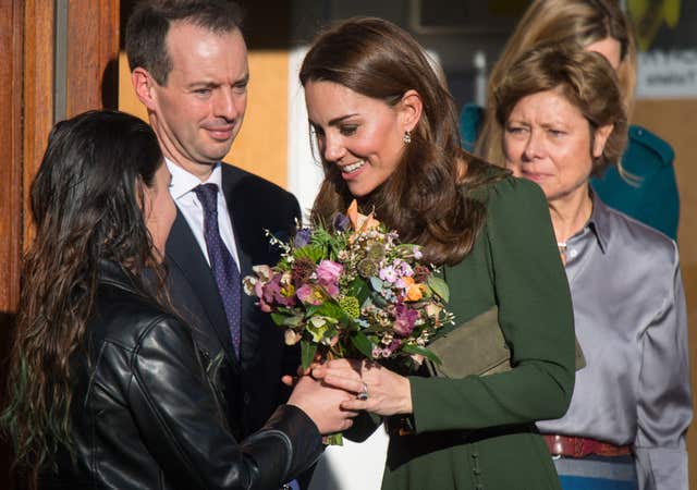 Kate receives a bouquet of flowers as she leaves