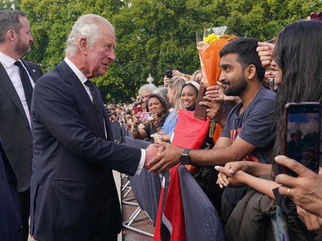 The King is greeted by well-wishers