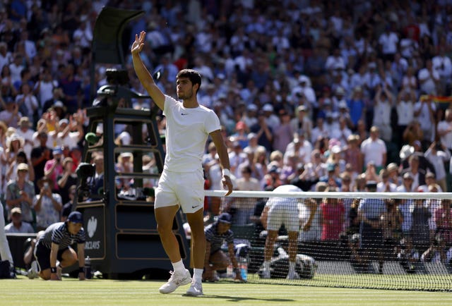 Carlos Alcaraz waves to the crowd after his debut Centre Court victory