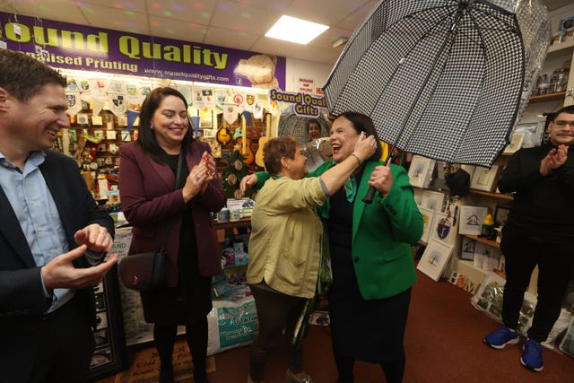 Helen Drumm gifting Mary Lou McDonald an umbrella