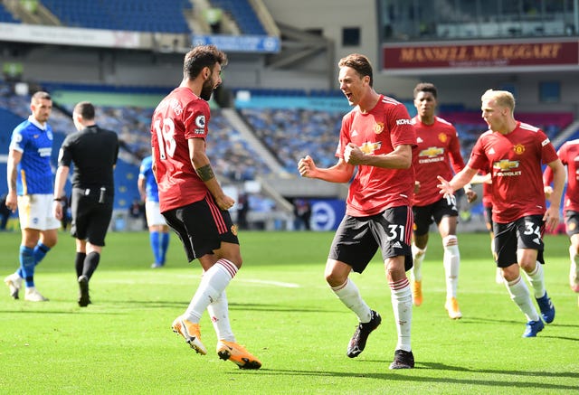 Manchester United's Bruno Fernandes (left) celebrates with Nemanja Matic after his last-gasp winner from the spot at Brighton