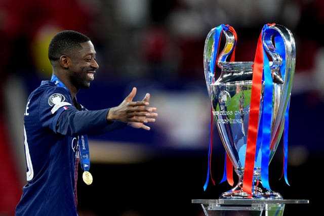 Ousmane Dembele walks up to the trophy after the UEFA Champions League Final