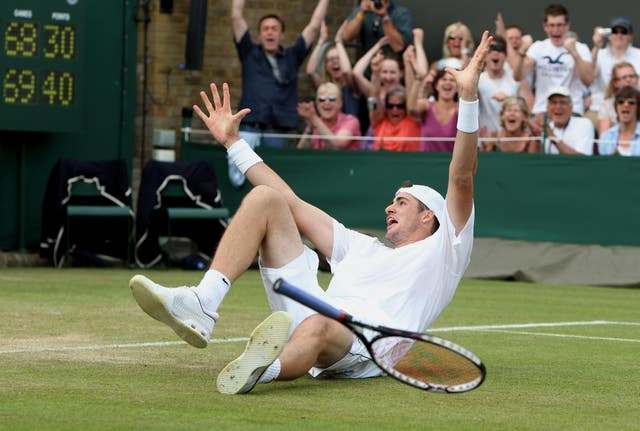 Isner celebrates his famous victory after finally breaking Mahut's serve in the fifth set - two days after they started the match