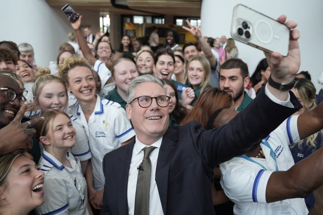 Labor leader Sir Keir Starmer takes a selfie with student nurses