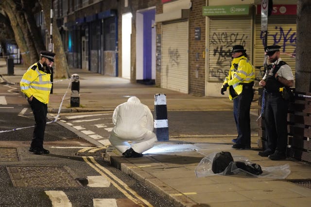 Police and forensics officers working at the scene.