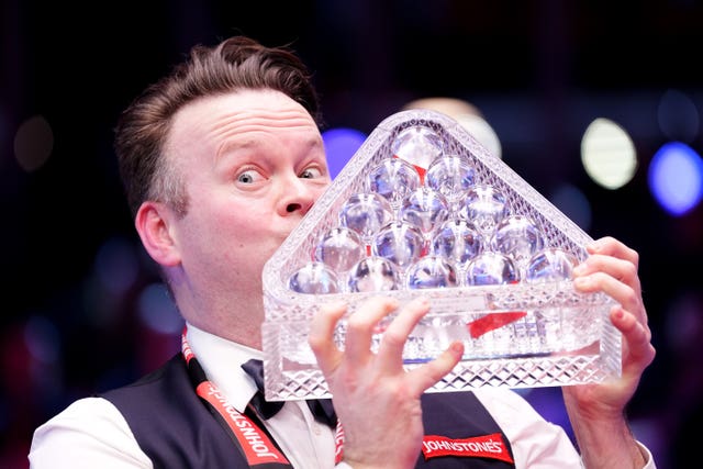 Shaun Murphy celebrates with the trophy after winning the Masters