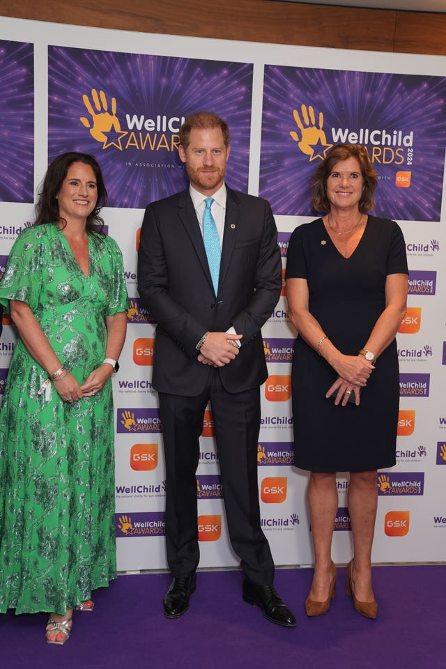 Duke of Sussex flanked by two women