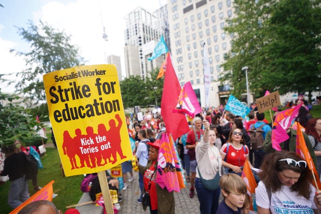 Members of the National Education Union (NEU) take part in a rally through Westminster to Parliament Square, London. 