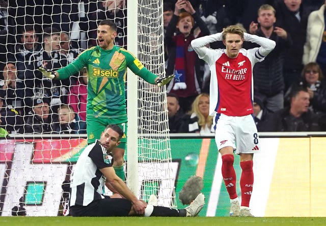 Martin Odegaard, right, puts his hands on his head after hitting the post against Newcastle