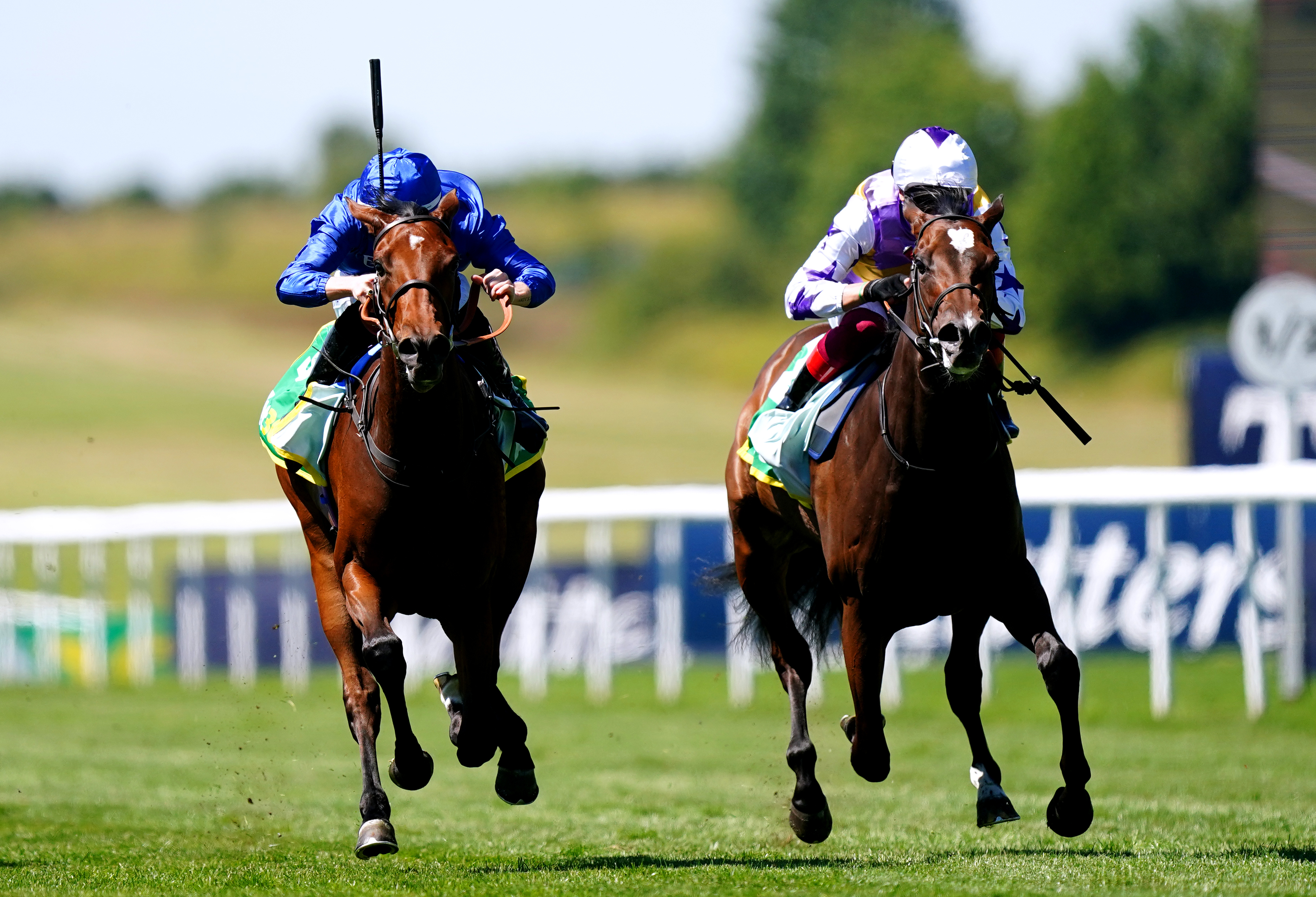 Mawj ridden by jockey Ray Dawson (left) on their way to winning the Duchess Of Cambridge Stakes on Festival Friday of the Moet and Chandon July Festival at Newmarket