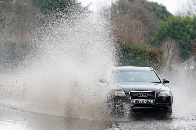 A car drives through floodwater near Swanley in Kent