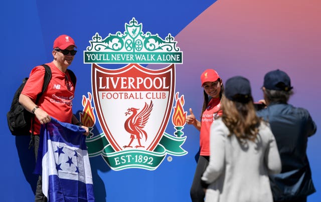 Liverpool fans pose for a photo in Puerta del Sol Square