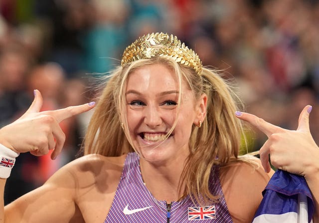 Molly Caudery points to a crown on her head after winning gold in the World Indoor Championships