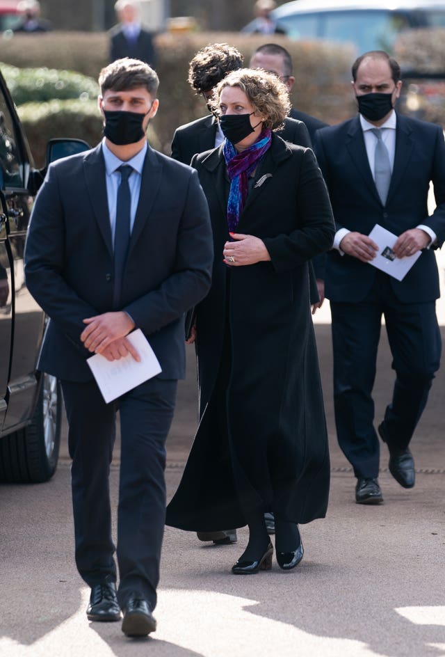 Daughter Lucy Teixeira and family leave after the service